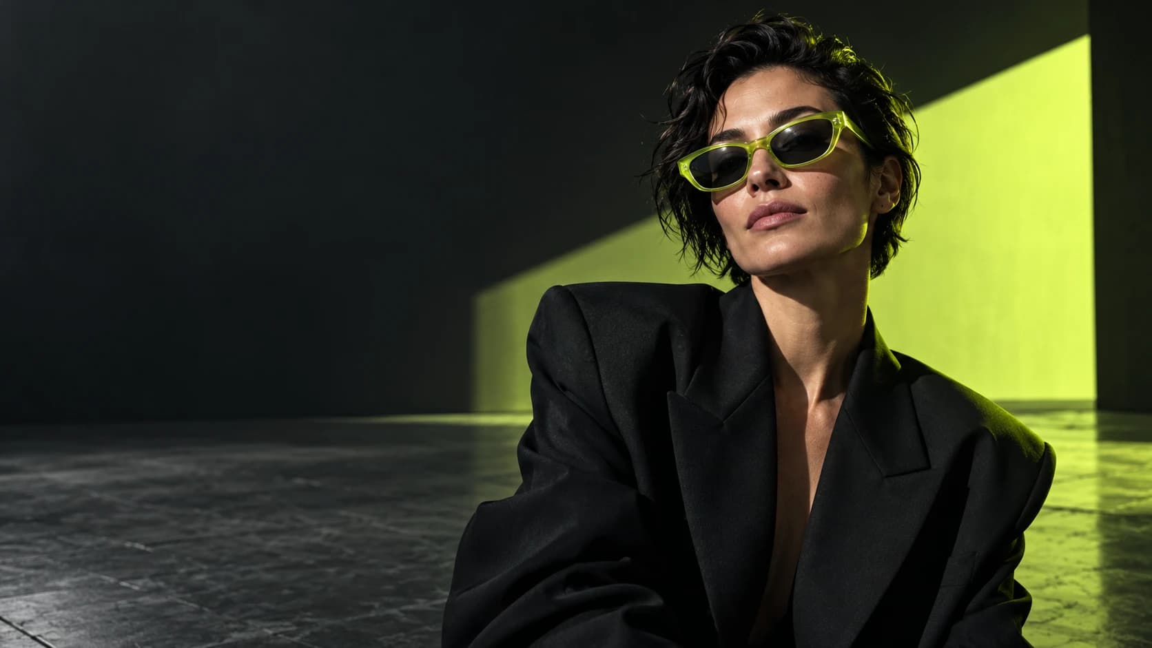 Original Adikt campaign: a creative director in lime sunglasses under cinematic studio lighting
